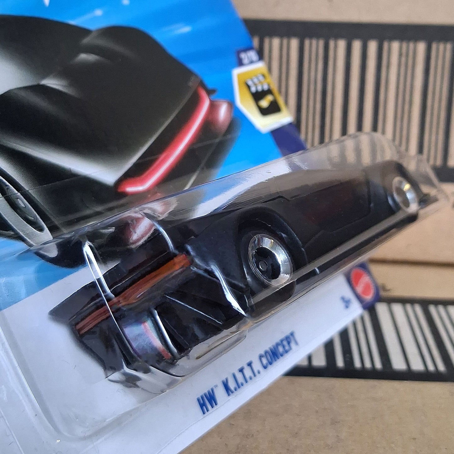 Rear angled view of Hot Wheels Knight Rider K.I.T.T. Concept 1/64 diecast with red scanner light in factory sealed packaging