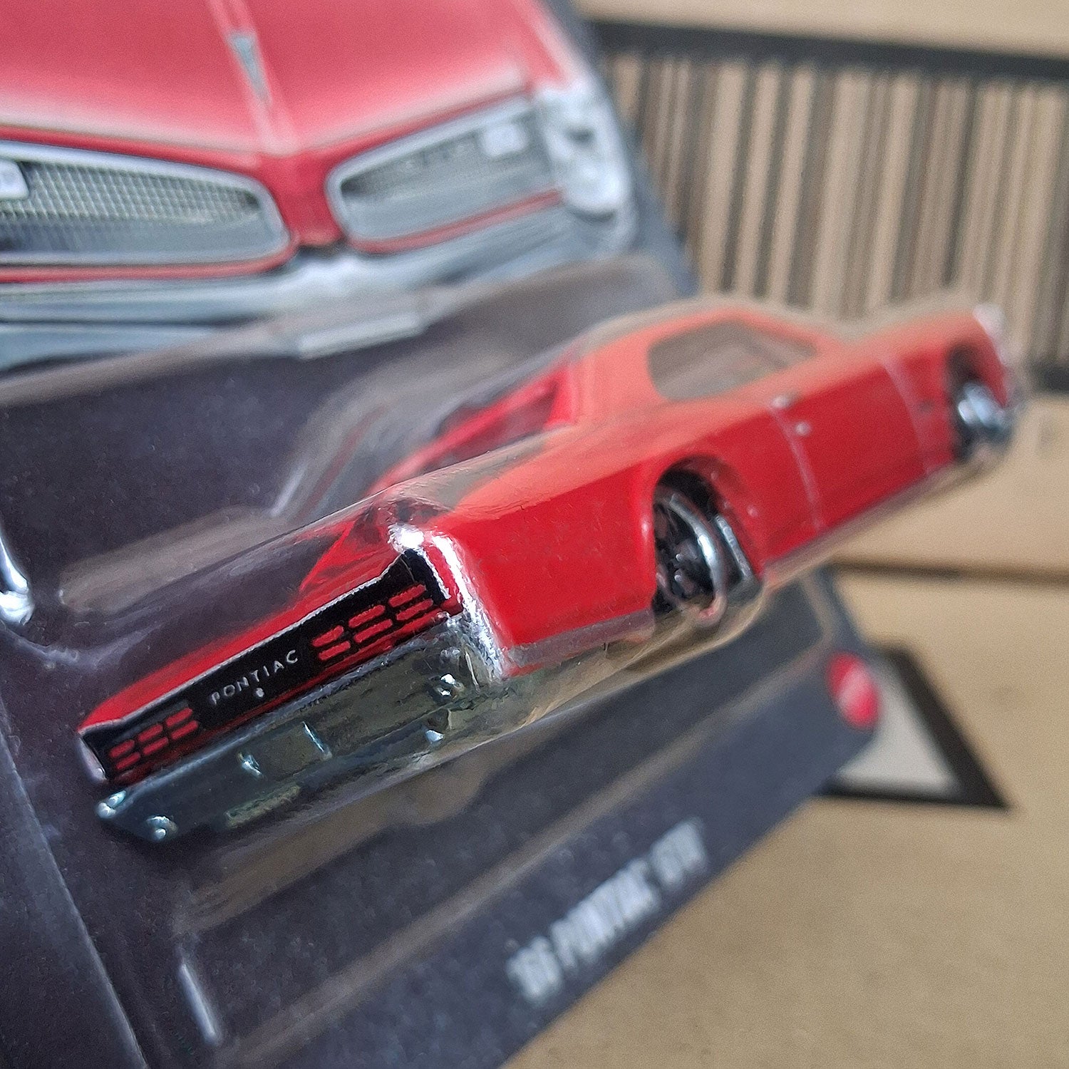 Rear detail close-up of Hot Wheels 1966 Pontiac GTO diecast car showing taillights and Pontiac logo