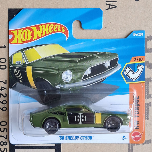 Hot Wheels '68 Shelby GT500 die-cast toy car in its original blister card packaging, featuring a green car with yellow and black racing stripes.