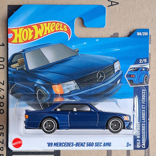 Hot Wheels Mattel '89 Mercedes-Benz 560 Sec AMG die-cast toy car in its original blue blister card packaging, featuring the Hot Wheels logo and Mercedes-Benz emblem.