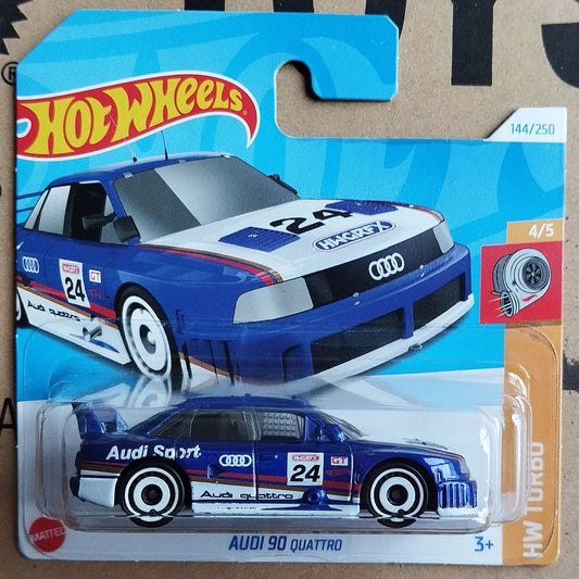 A Hot Wheels Mattel die-cast toy car of the 1994 Audi 90 Quattro, shown in its original blister pack on a cardboard backing card.