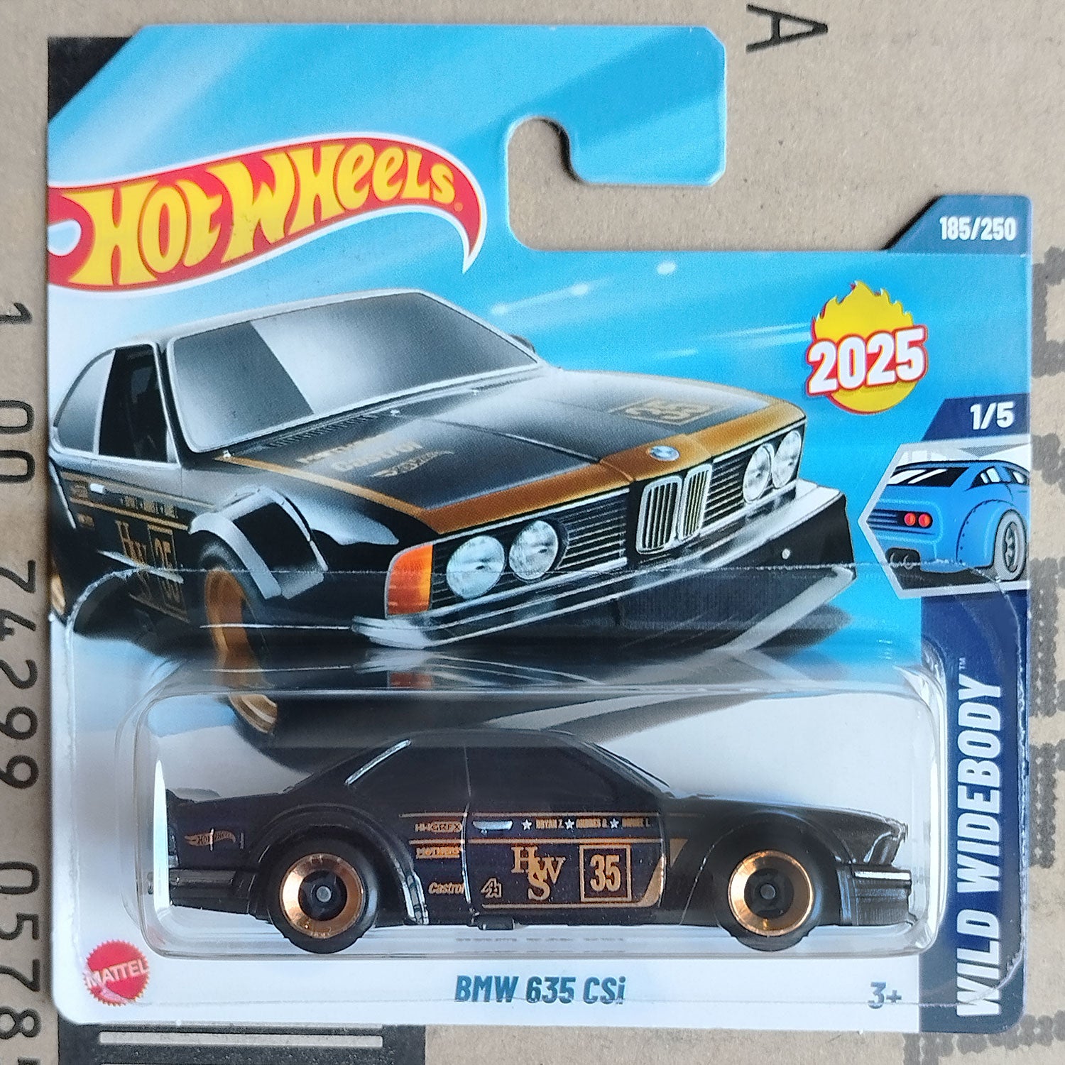 Hot Wheels Mattel BMW 635 CSi die-cast toy car in its original blister card packaging, featuring a black car with gold and white racing decals.
