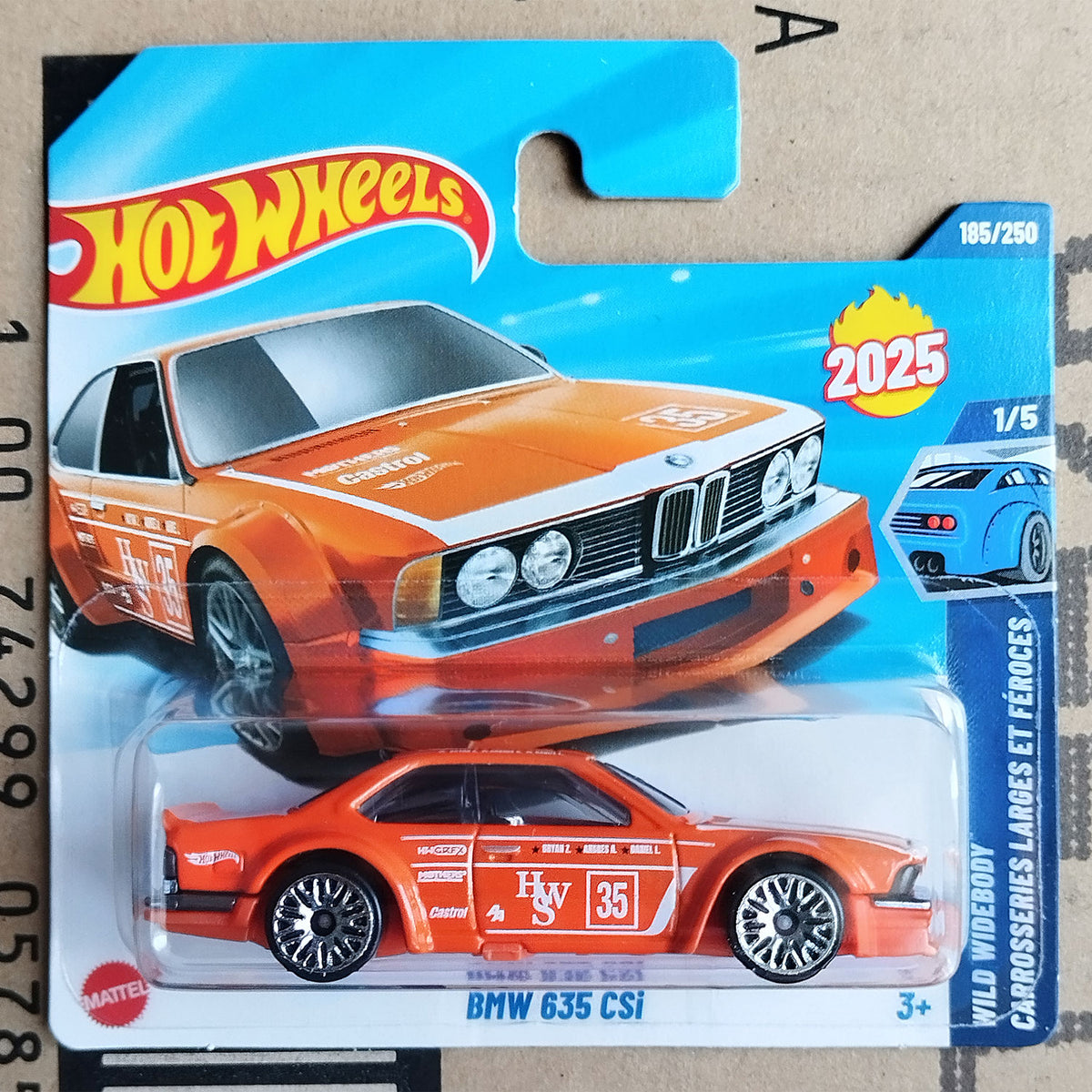 Hot Wheels BMW 635 CSi in orange racing livery from the 2025 Wild Widebody series. Collectible classic BMW coupe, new in original packaging.