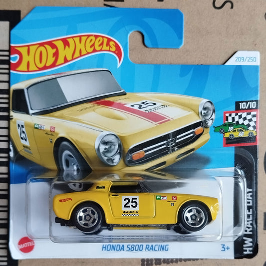 Hot Wheels die-cast toy car package featuring a yellow Honda S800 Racing model car in clear blister packaging, with the Hot Wheels logo and card art on a cardboard backing.