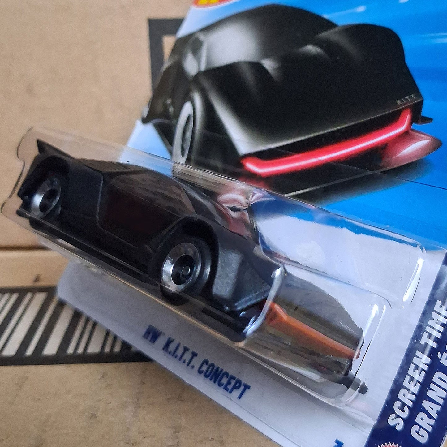 Angled side view of Hot Wheels Knight Rider K.I.T.T. Concept 1/64 diecast with red scanner light in sealed packaging