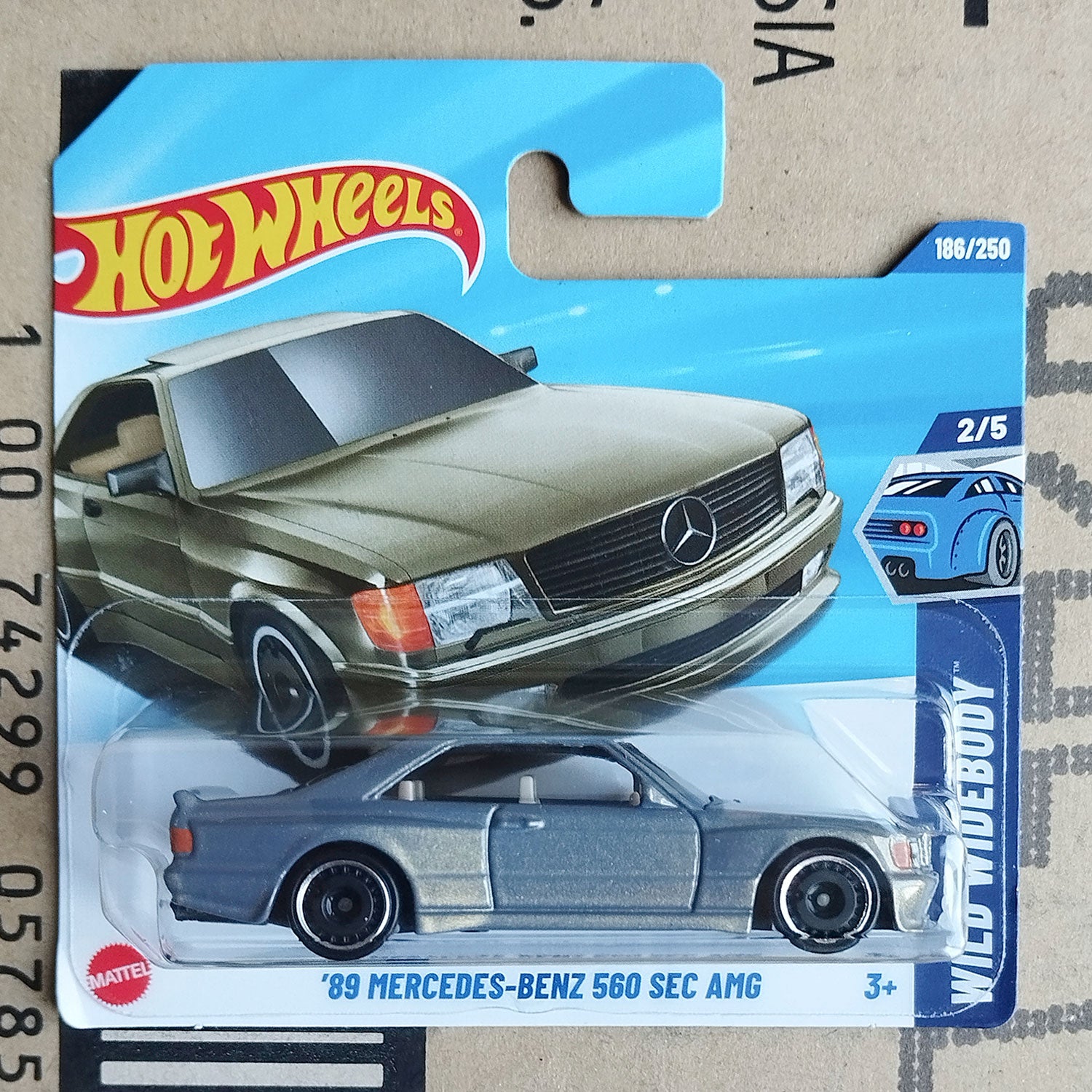 Hot Wheels 1989 Mercedes-Benz 560 SEC AMG diecast 1/64 car in original packaging on cardboard background