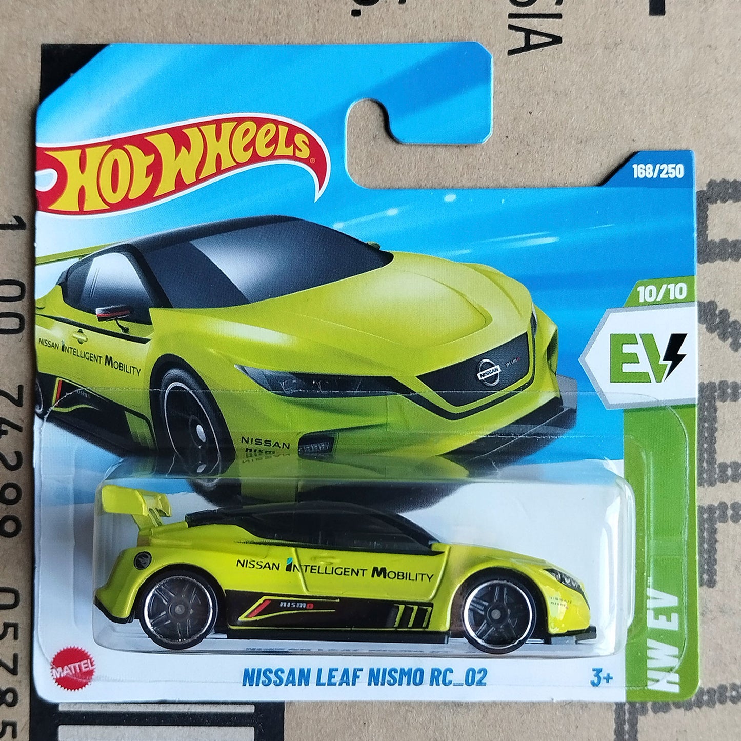 Hot Wheels Mattel Nissan Leaf Nismo RC-02 electric toy car in its original blister packaging, featuring a bright yellow-green body with black and red accents.
