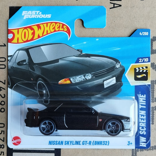 Hot Wheels toy car of the Nissan Skyline GT-R (BNR32) in a black die-cast model, packaged on its original blue blister card with Hot Wheels branding.
