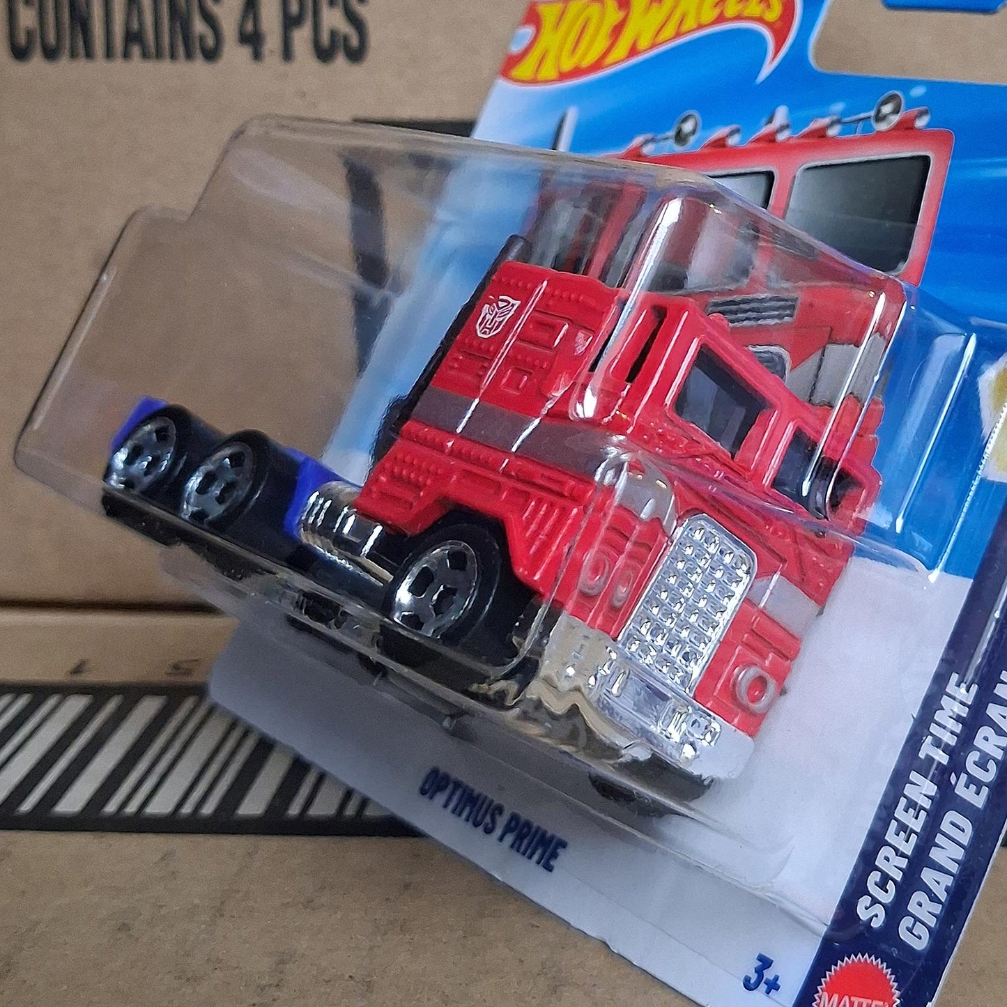 Hot Wheels Optimus Prime Transformers 1/64 diecast Freightliner truck in original blister packaging side angle view