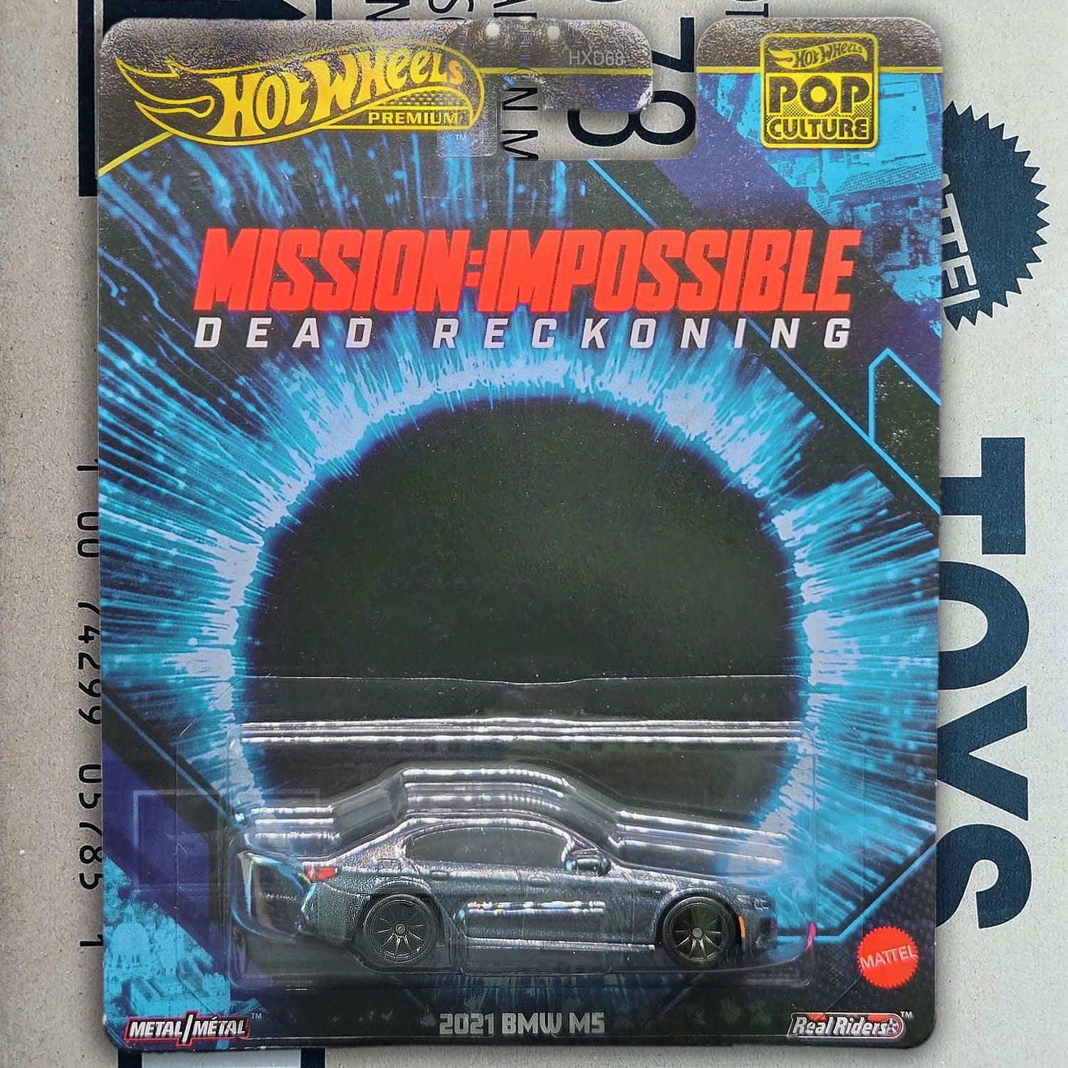 Hot Wheels Premium 2021 BMW M5 from Mission Impossible Dead Reckoning movie toy car packaging on a gray background