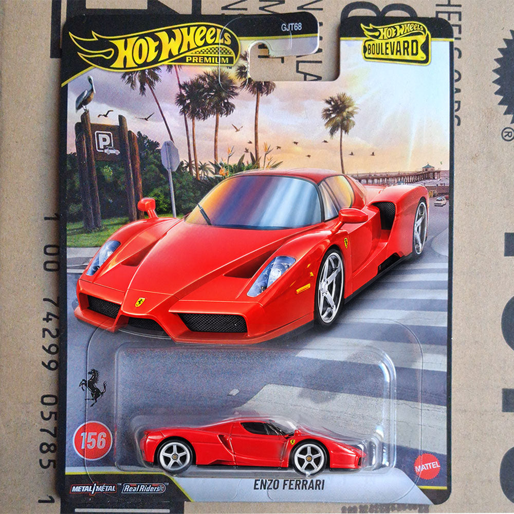 Hot Wheels die-cast toy car of Enzo Ferrari in red, still in its original blister card packaging, displayed on a cardboard shipping box.