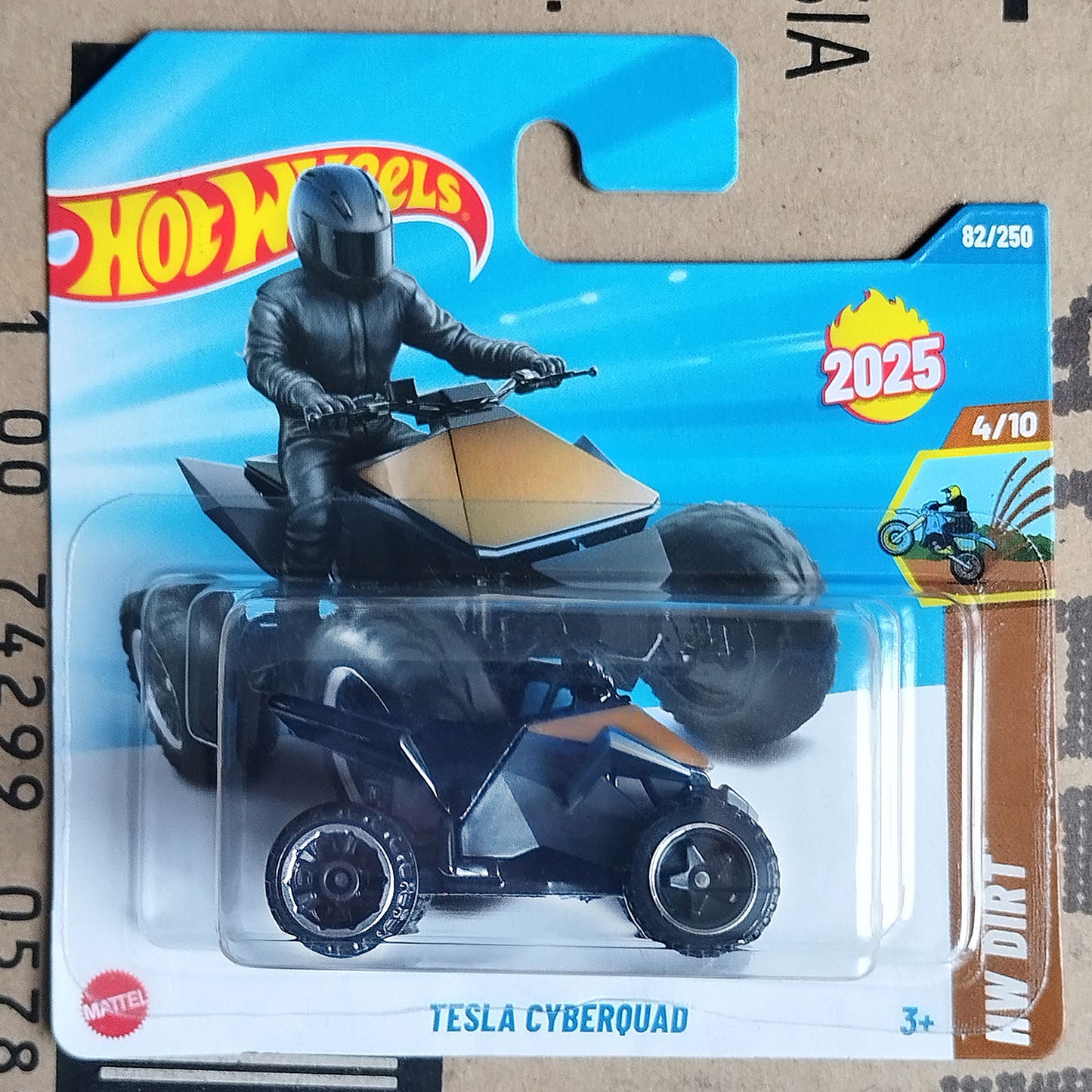 Hot Wheels Mattel Tesla Cyberquad toy vehicle in its original blister card packaging, featuring a black and orange ATV with a rider figure on the card.