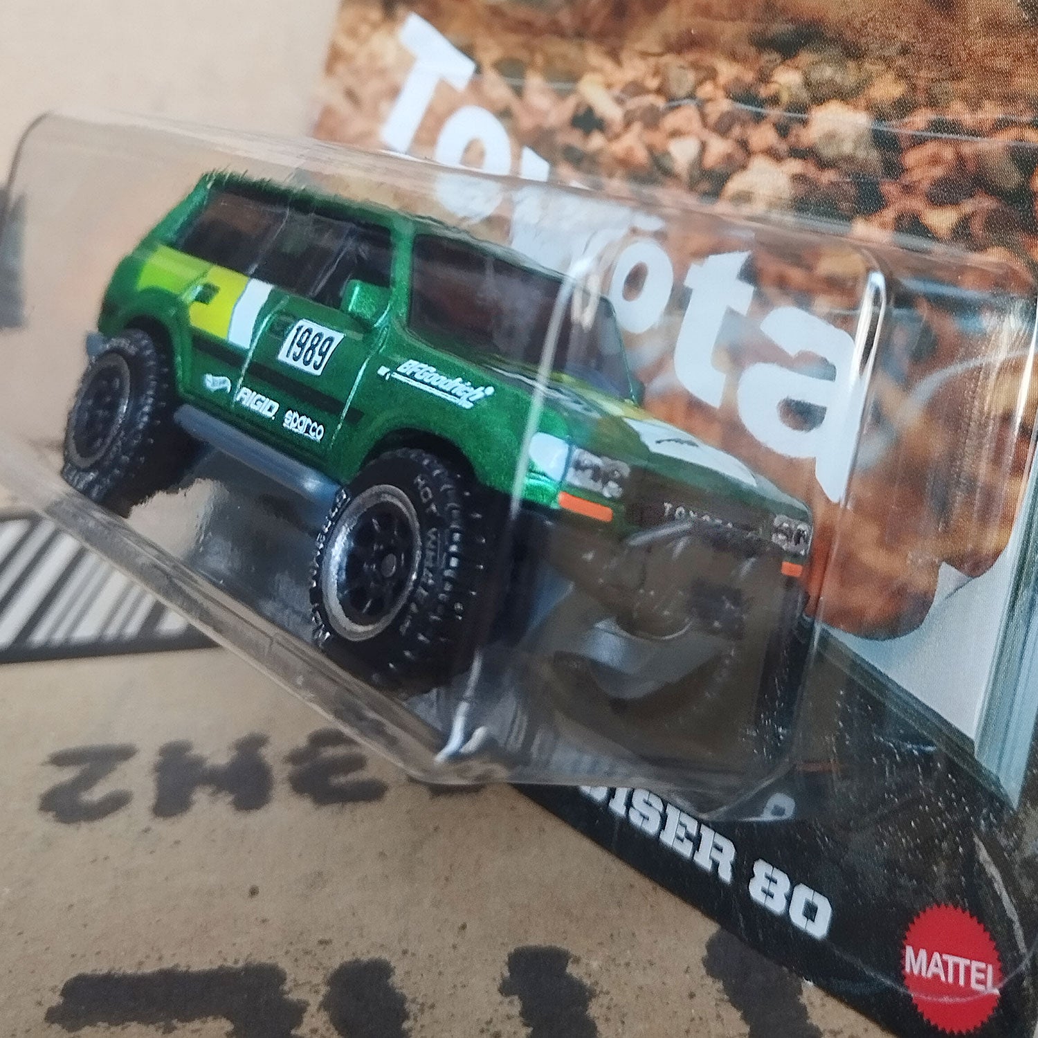 Angled close-up view of Hot Wheels Toyota Land Cruiser 80 green 1/64 diecast off-road SUV in Silver Series packaging