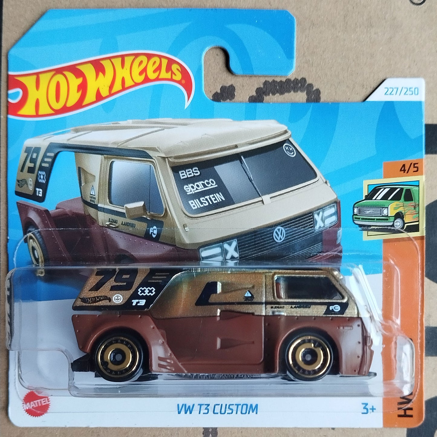 Hot Wheels die-cast toy car of a customized brown and beige Volkswagen T3 van, packaged on its original blue and orange blister card.