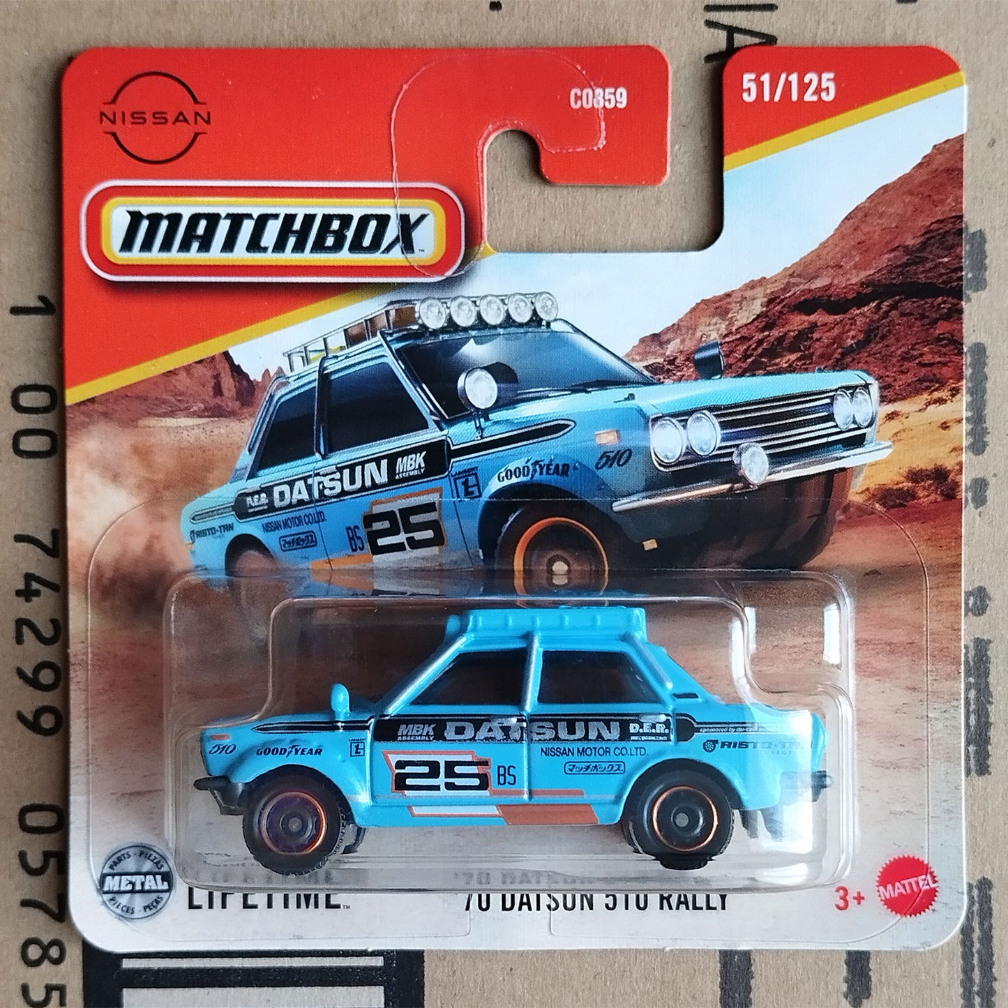 Matchbox die-cast toy car of the Nissan Datsun 210 Rally car, number 25, in its original blister pack card. The toy car is light blue with black and white racing decals.