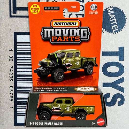 Matchbox Moving Parts 1947 Dodge Power Wagon toy truck in its original blister packaging, featuring an olive green die-cast model with a shark mouth graphic on the side, set against a cardboard backdrop with a barcode.
