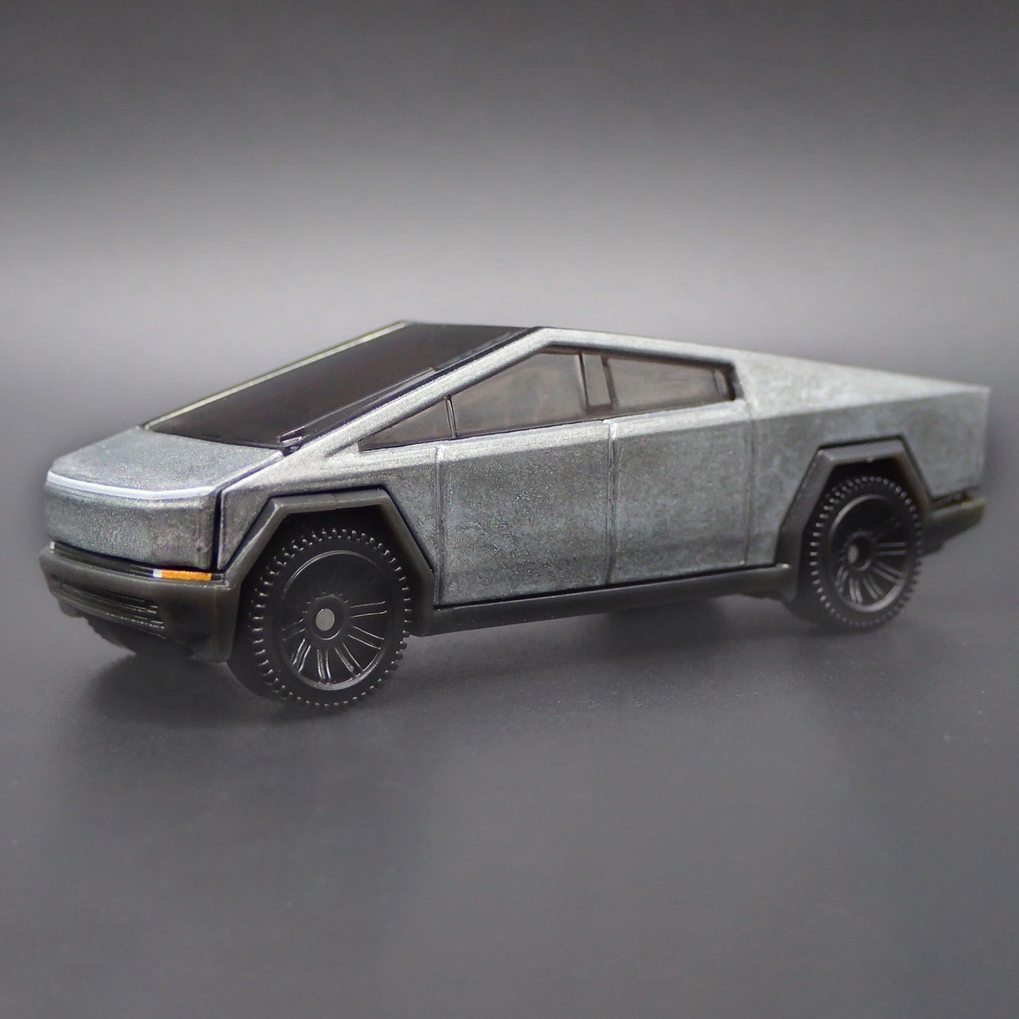 Matchbox Tesla Cybertruck 1/64 diecast model close-up showing detailed body design and wheels.