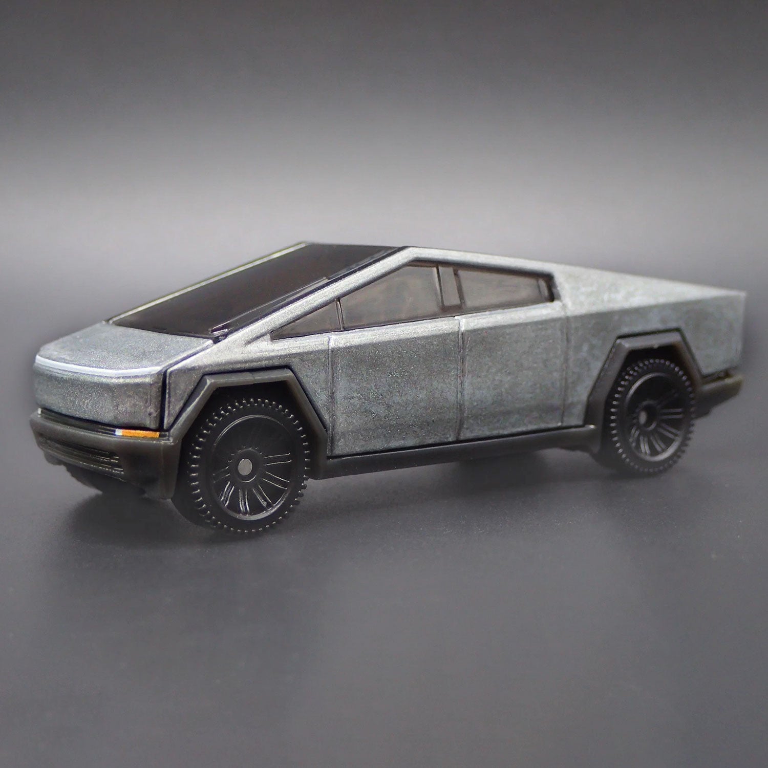 Matchbox Tesla Cybertruck 1/64 diecast model close-up showing detailed body design and wheels.