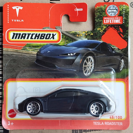 Matchbox die-cast toy car of the Tesla Roadster, model CH859, in its original red and white blister card packaging.