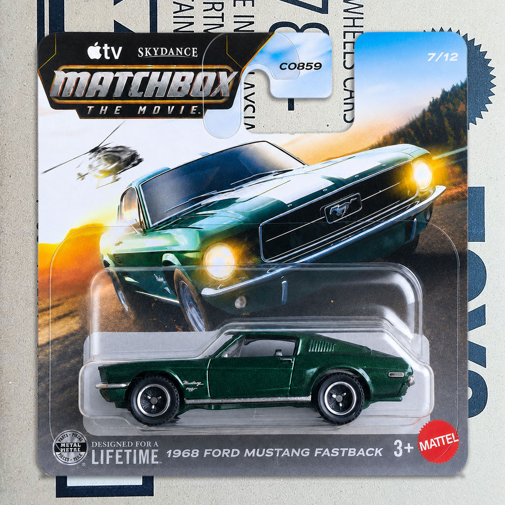 A Matchbox The Movie die-cast toy car of a 1968 Ford Mustang Fastback in dark green, packaged on its original cardback featuring a large photo of the car and branding.
